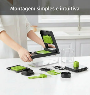 Cortador de legumes multifuncional desmontado com peças verdes e pretas em cozinha moderna